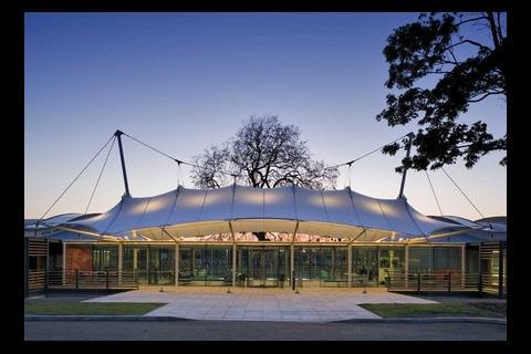 On either side of the fabric roof of the reception hall lie the indoor courts and the office wing